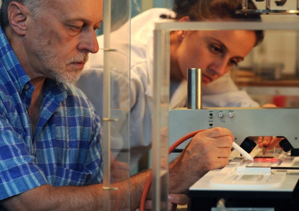 Photo gallery - category: Research - PhD Andrzej Żywociński and a PhD student Patrycja Nitoń near the Langmuir tank with the use of which they examine liquid-crystal monolayers on the water surface.